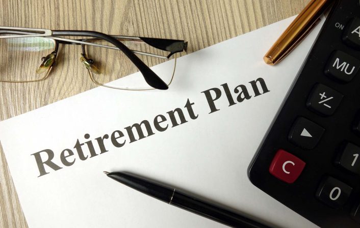Retirement plan with calculator pen and glasses, personal finance planning